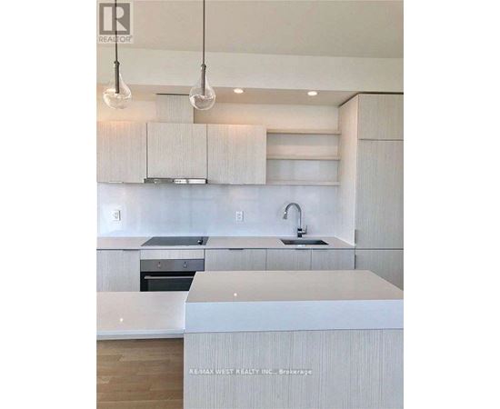 A modern kitchen with white cabinets and a center island.