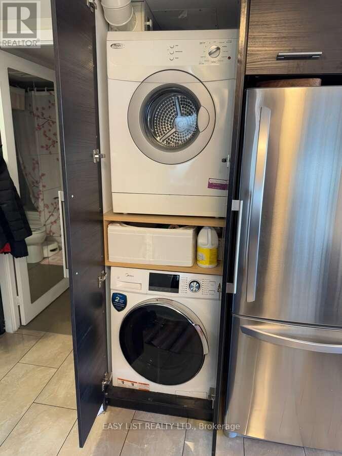 A washing machine and dryer are stacked in a small space.