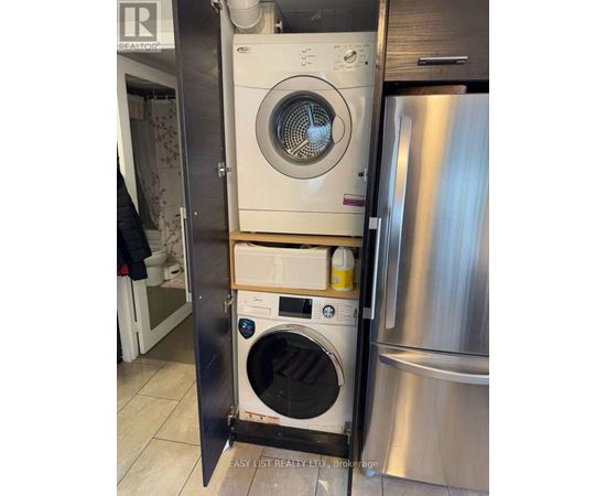 A washing machine and dryer are stacked in a small space.