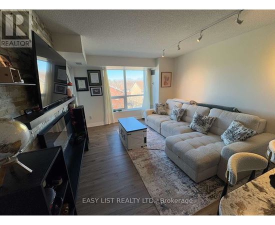 A living room with a grey couch and a flat screen TV.