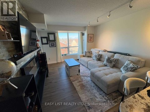 A living room with a grey couch and a flat screen TV.
