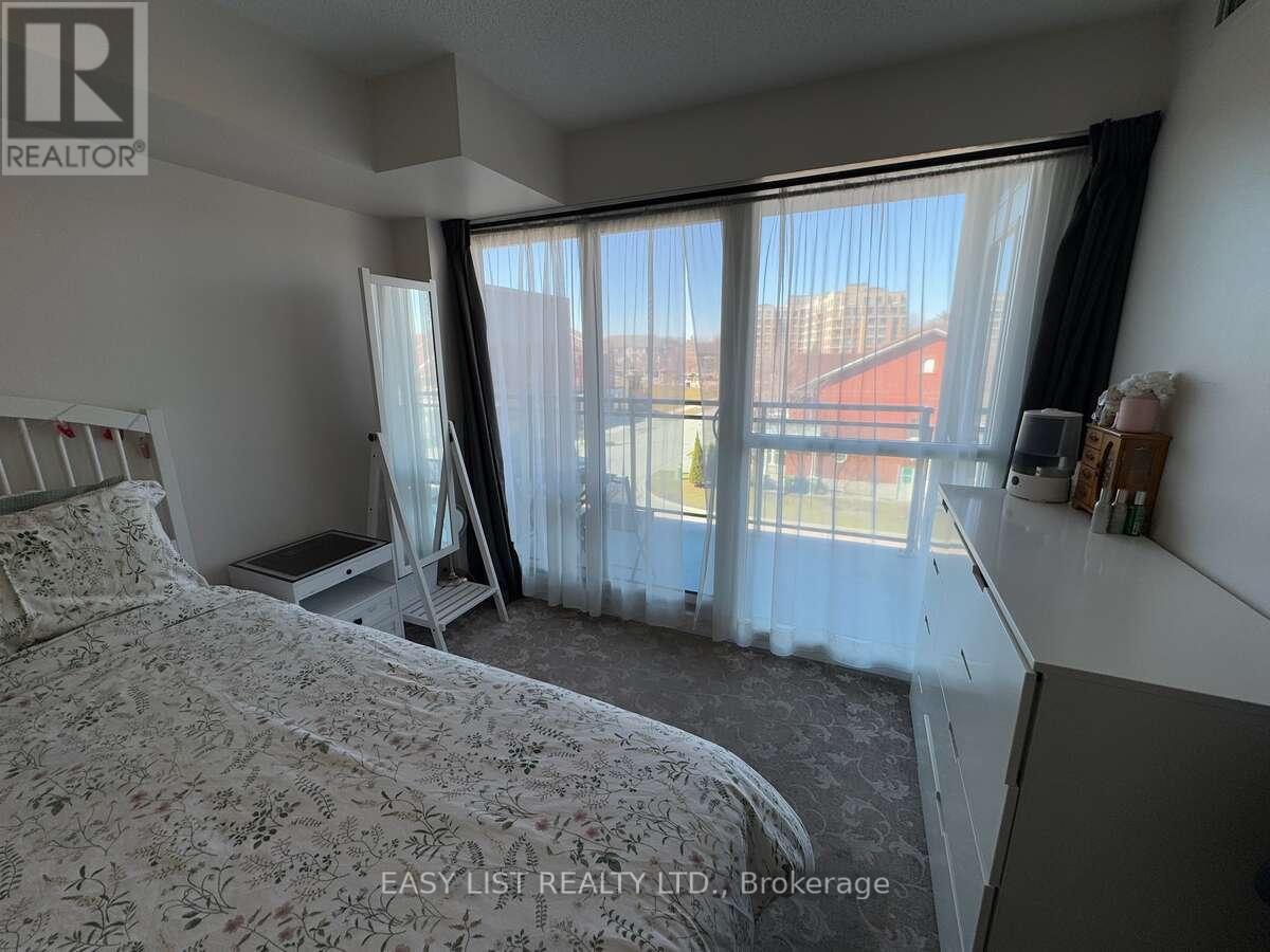 A bedroom with a large bed and a window with curtains.