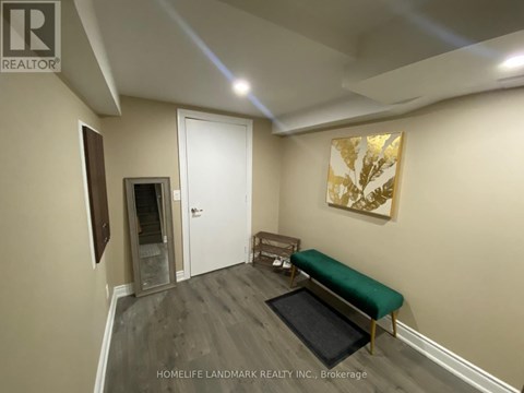 A room with a bench and a painting on the wall.