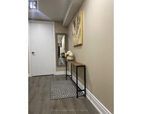 A hallway with a bench and a rug on the floor.