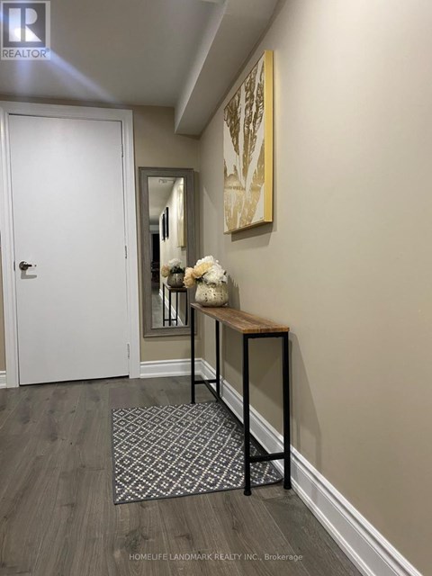 A hallway with a bench and a rug on the floor.