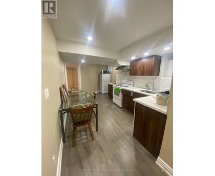 A kitchen with a table and chairs in it.