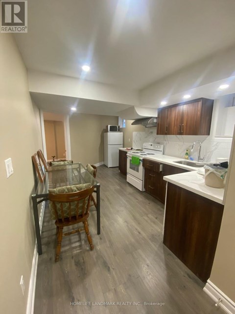 A kitchen with a table and chairs in it.