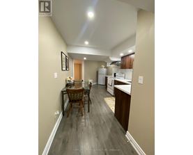A well-lit kitchen and dining area with wooden floors and modern appliances.
