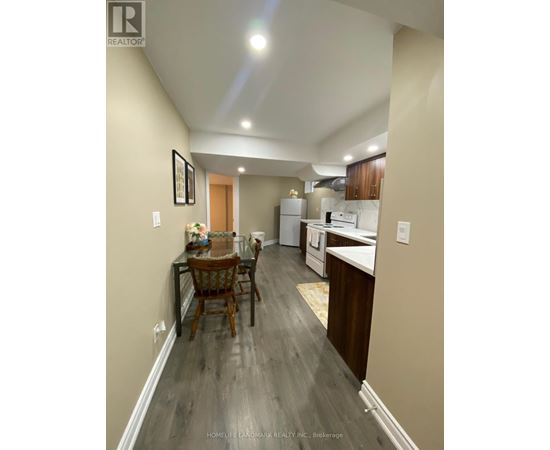 A well-lit kitchen and dining area with wooden floors and modern appliances.