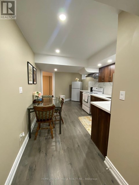 A well-lit kitchen and dining area with wooden floors and modern appliances.