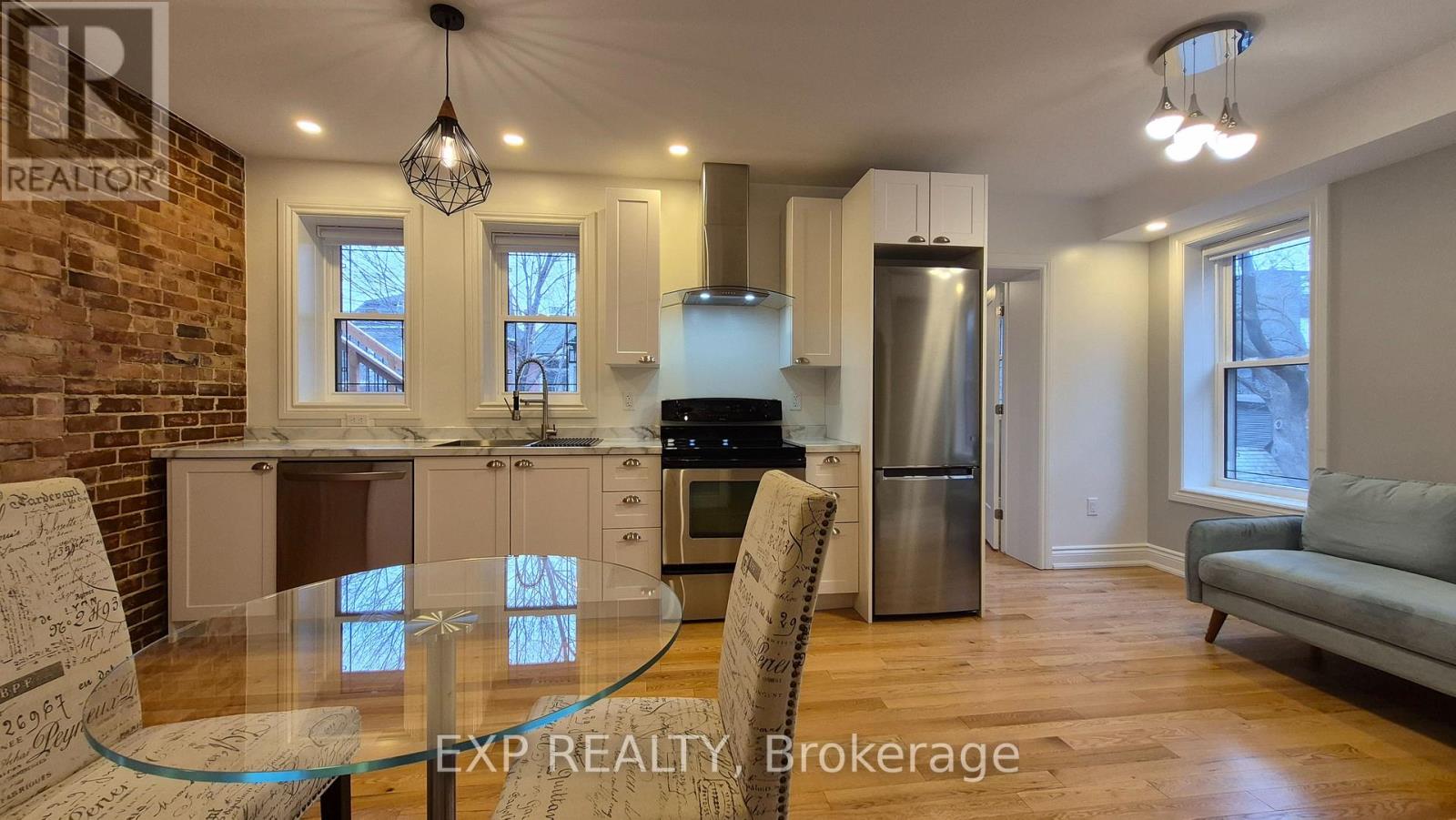 A modern kitchen with a glass table and chairs.