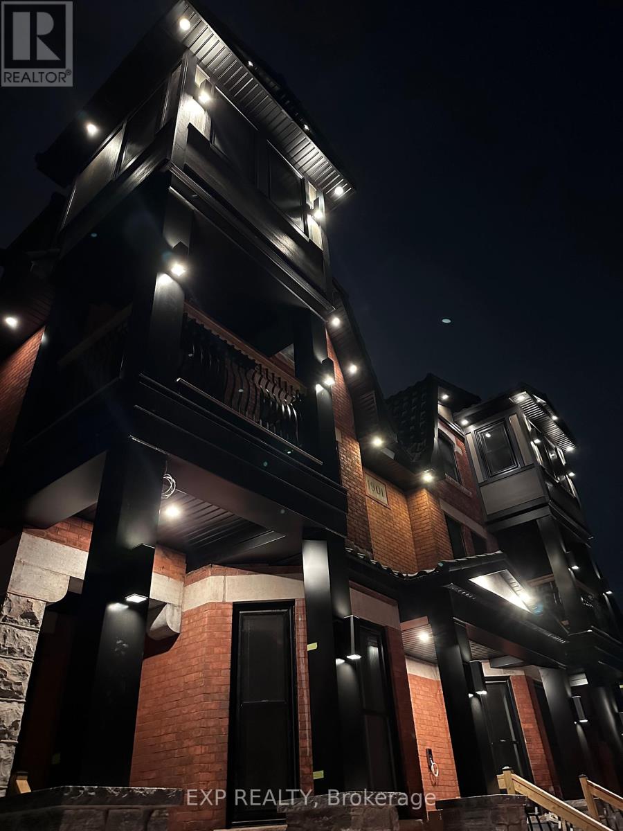 A nighttime view of a building with a sign that reads "EXP Realty, Brokerage.".