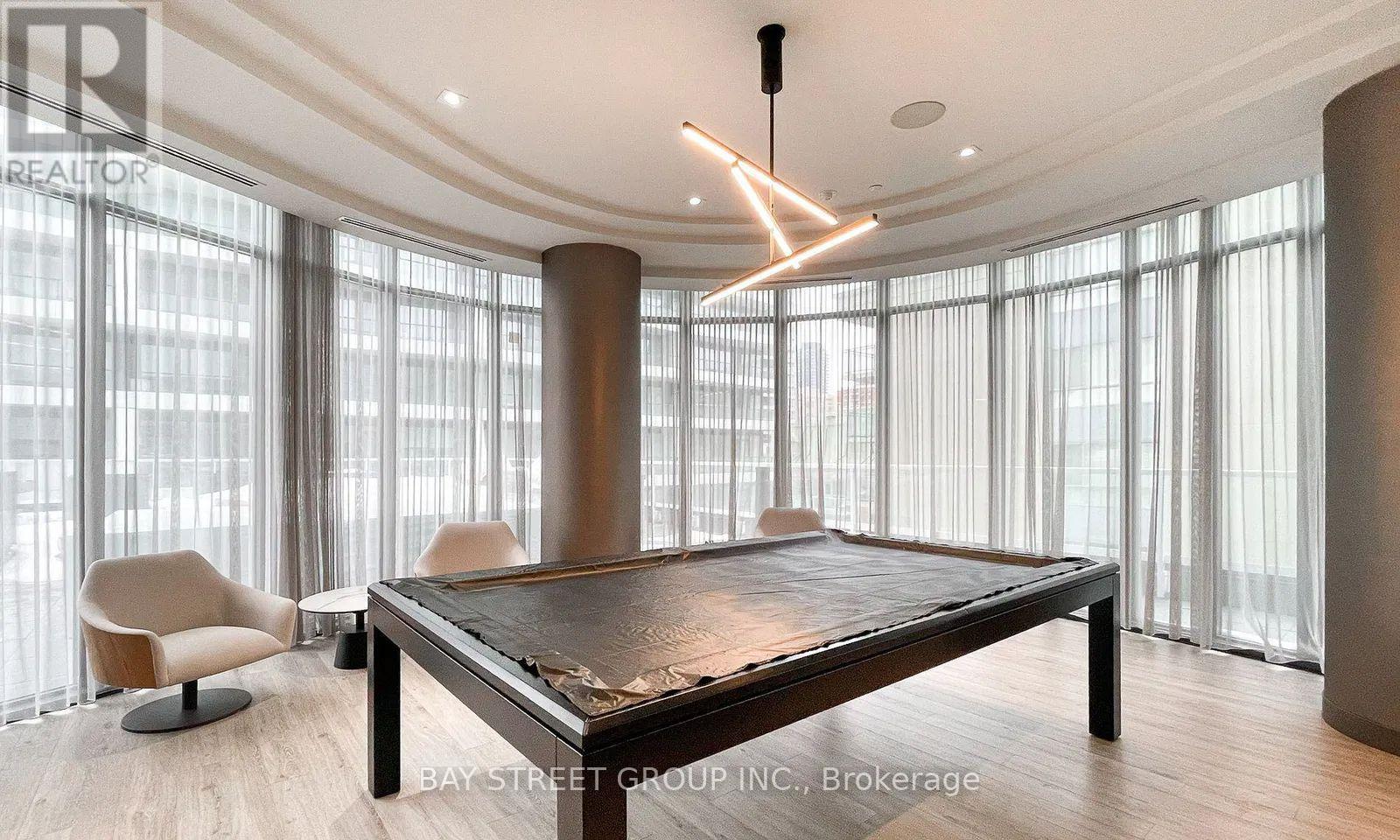 A modern dining room with a large table and chairs.