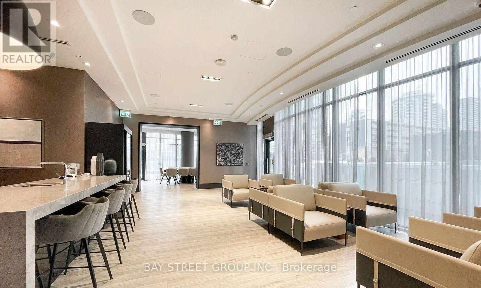 A modern living room with a long table and chairs.