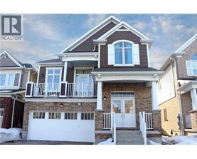 A house with a brown roof and a white garage door.