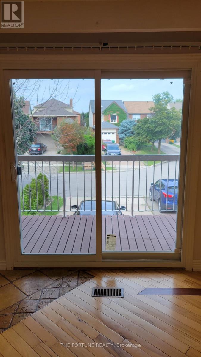 A view of a residential street through a sliding glass door.