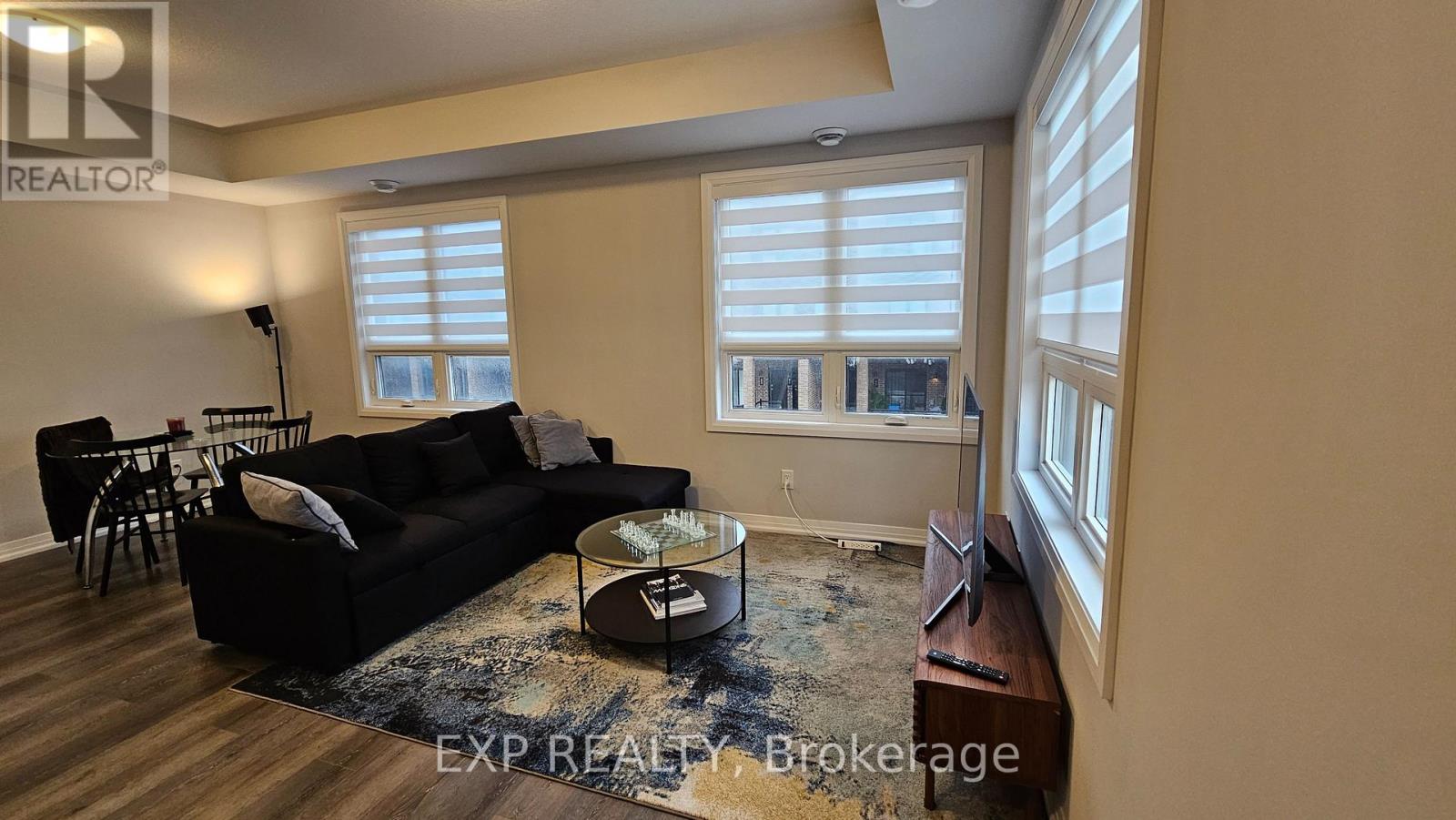 A living room with a black couch and a coffee table.