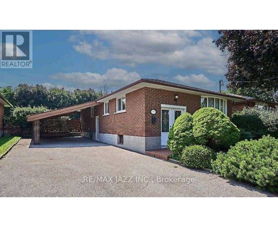 A house with a red brick exterior and a white door is for sale.