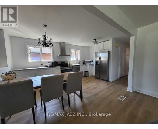 A dining room with a table set for four.