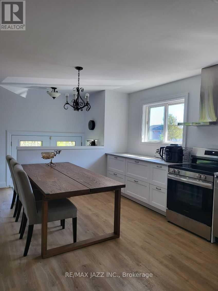 A dining room with a wooden table and chairs.