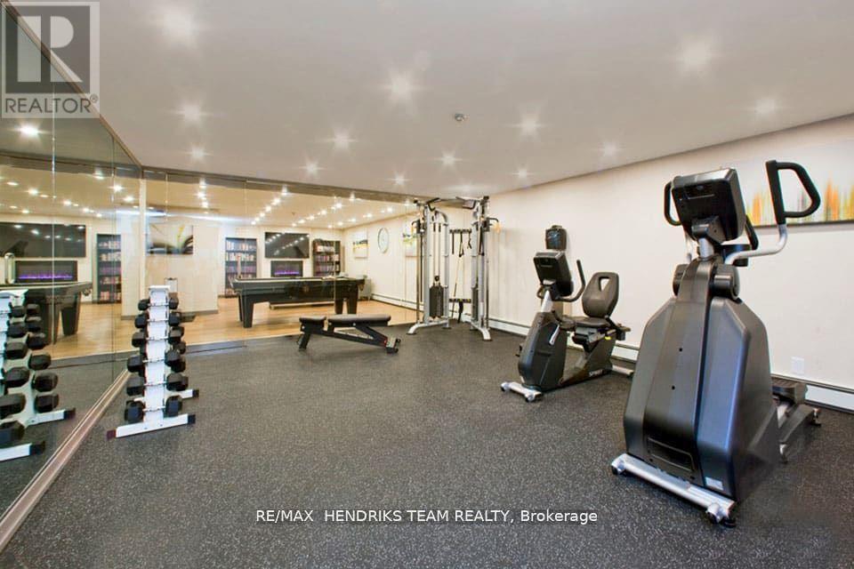A gym with a variety of equipment including a treadmill, weights, and a bench press.