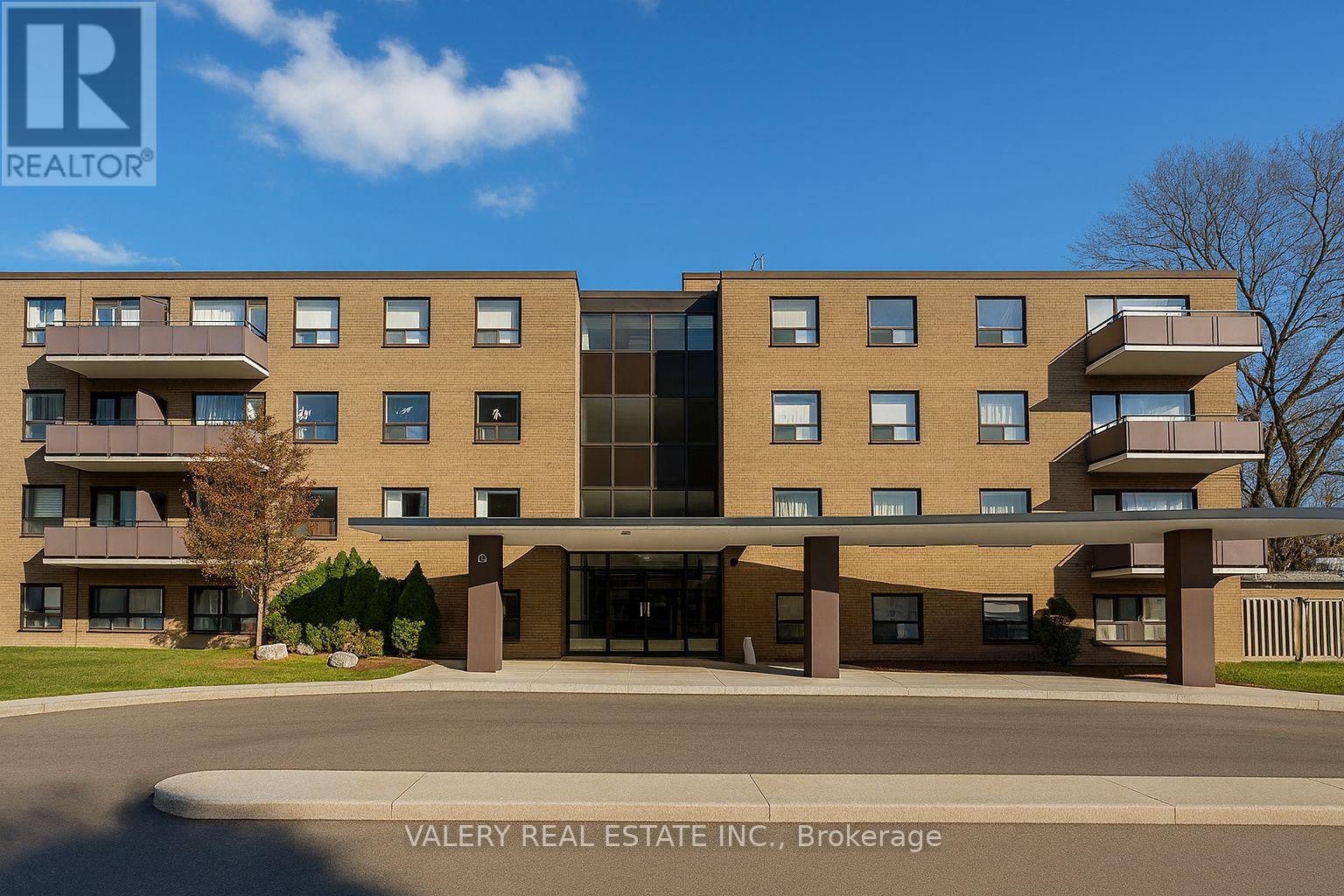 A modern apartment building with a clear blue sky in the background.