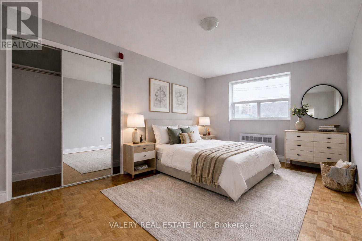 A bedroom with a bed, nightstands, and a dresser.