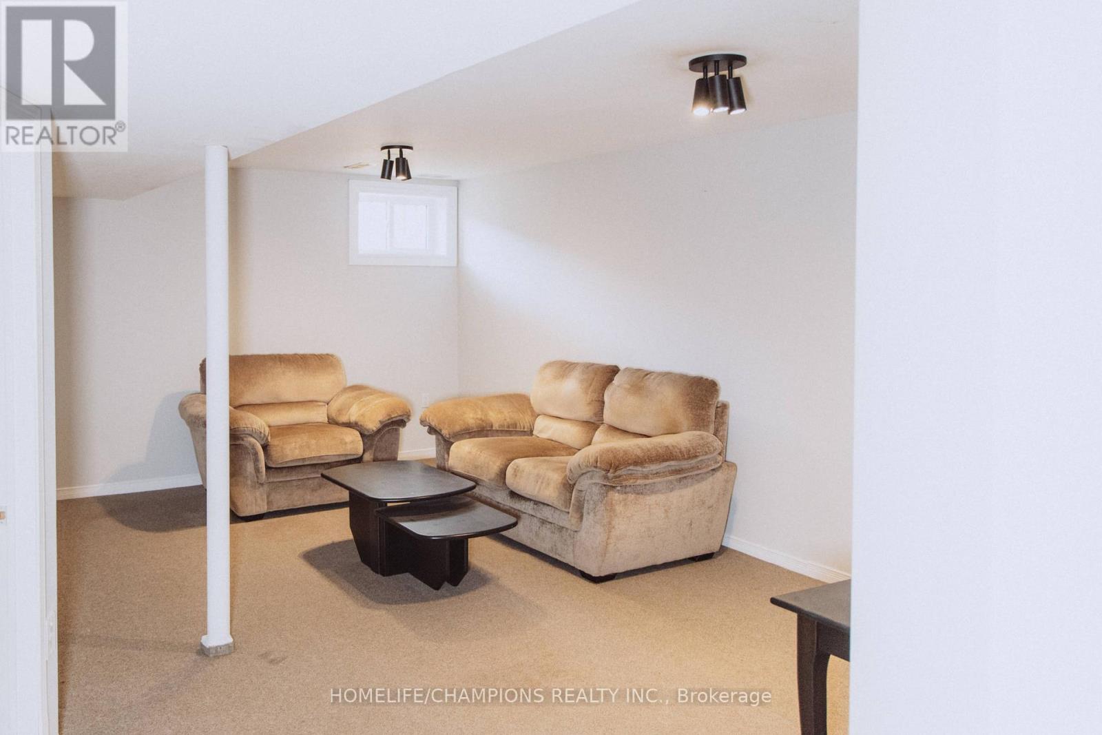 A living room with a couch, armchairs, and a coffee table.