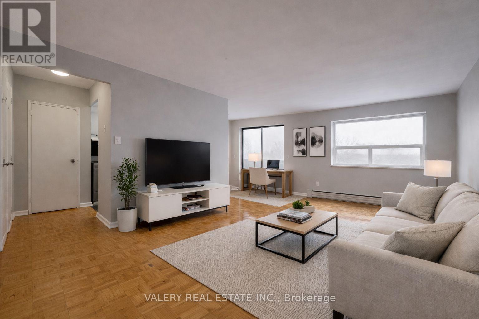 A living room with a television, couch, and coffee table.
