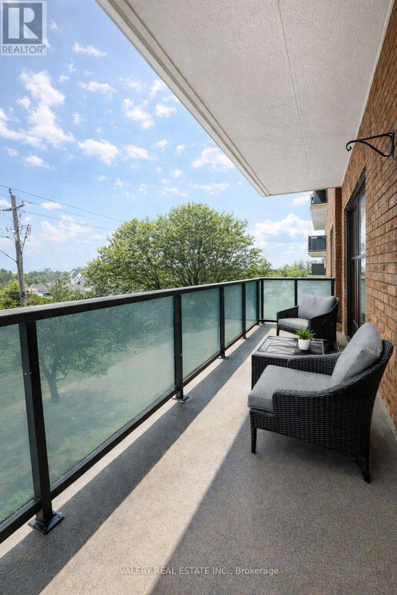 A balcony with a chair and a table with a plant on it.