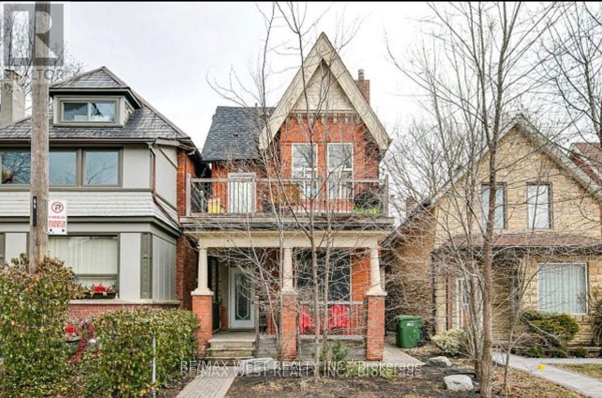 A house with a red door and a sign that says "No Parking".