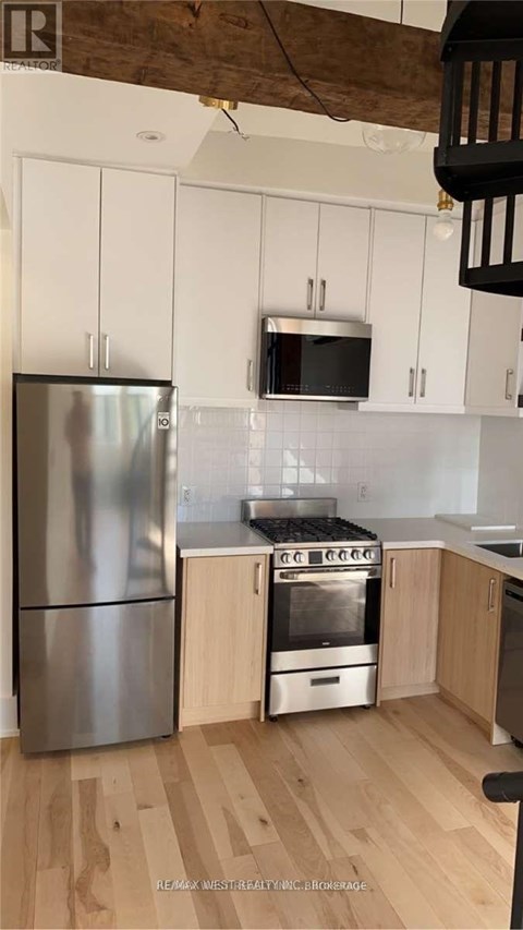 A kitchen with a stainless steel refrigerator and oven.
