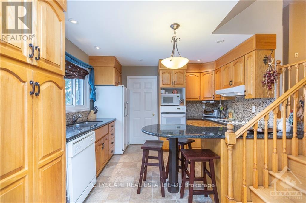 A kitchen with wooden cabinets and a black countertop.