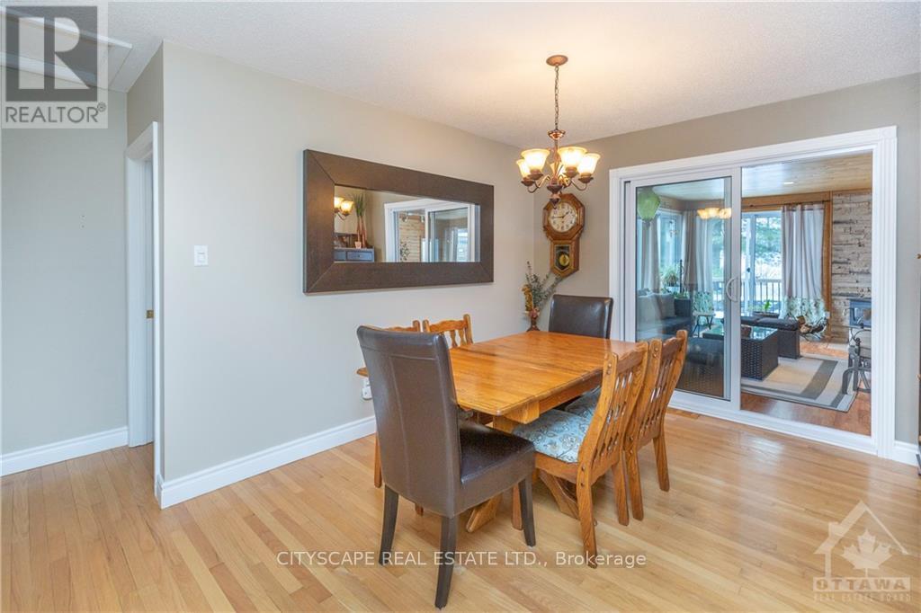 A dining room with a wooden table and chairs.
