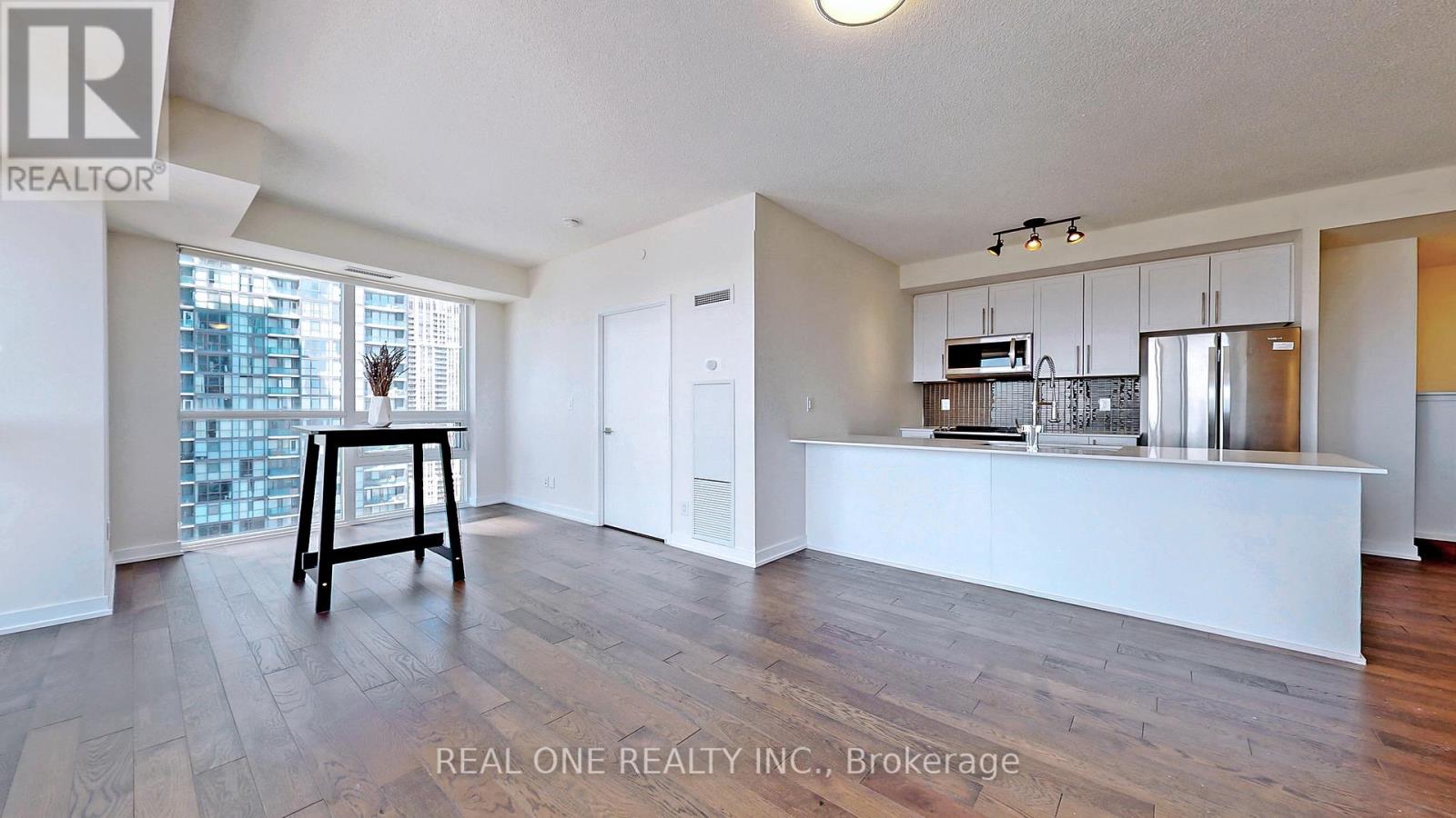 A realtor's table is in the middle of a spacious living room.