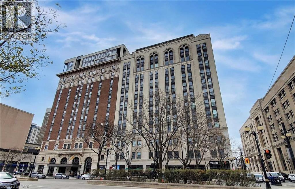 A large, multi-story building with a mix of brick and white exterior walls.