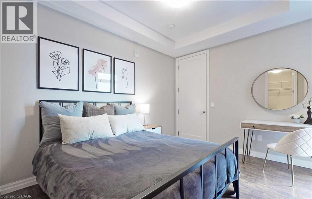 A bedroom with a large bed and a desk with a mirror.