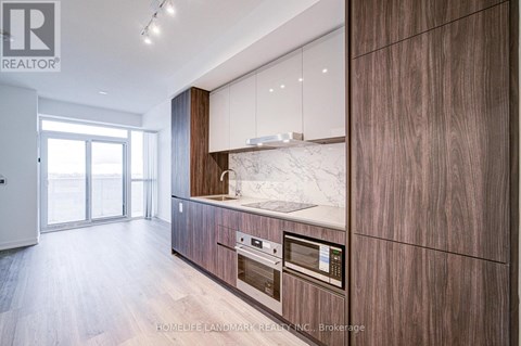 A modern kitchen with wooden cabinets and a marble countertop.