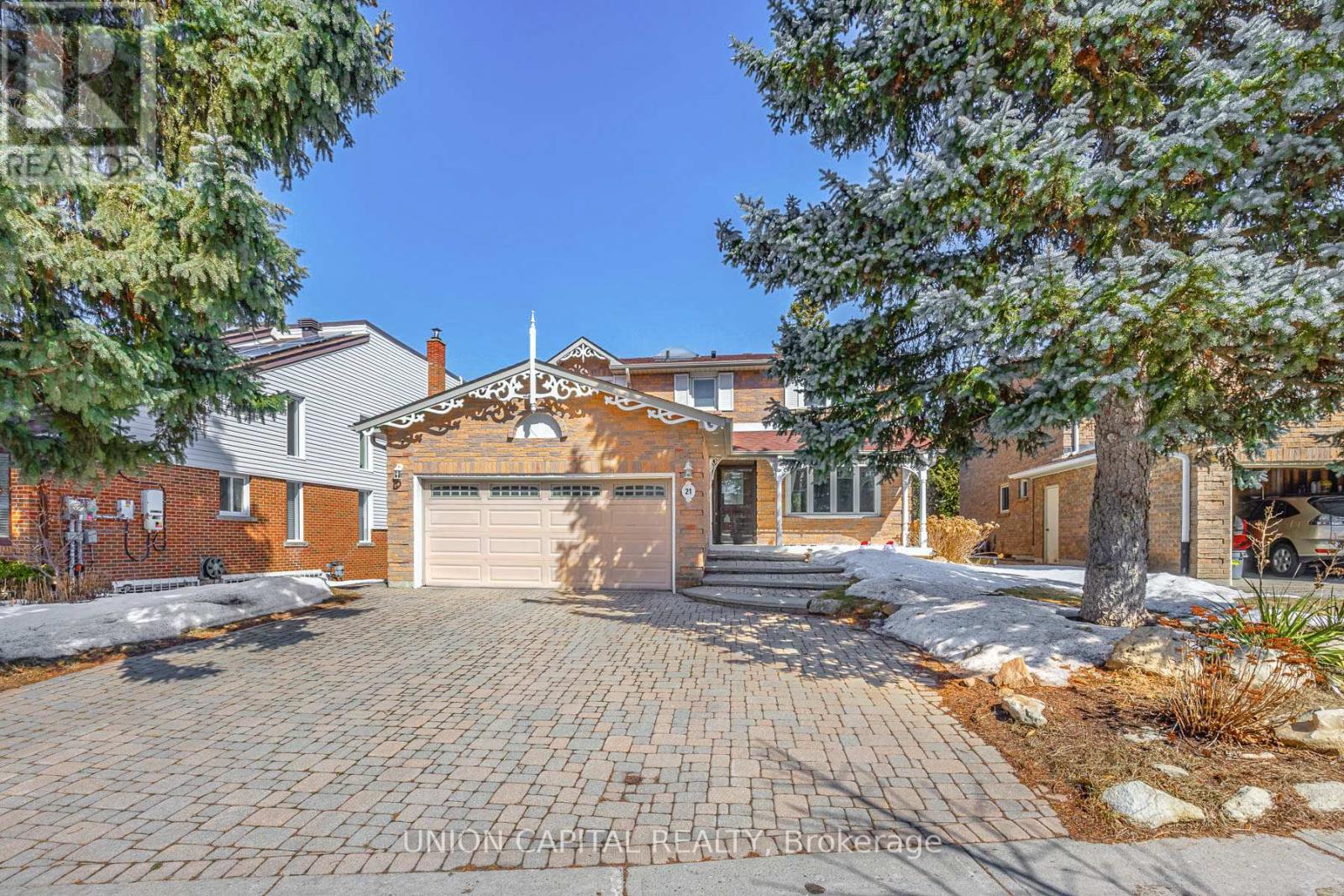 A house with a driveway and garage is for sale.