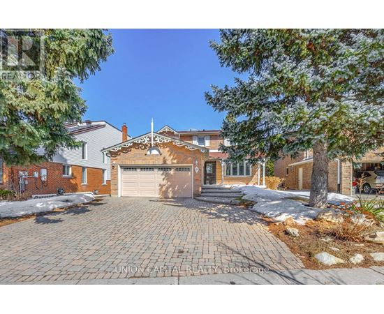 A house with a driveway and garage is for sale.