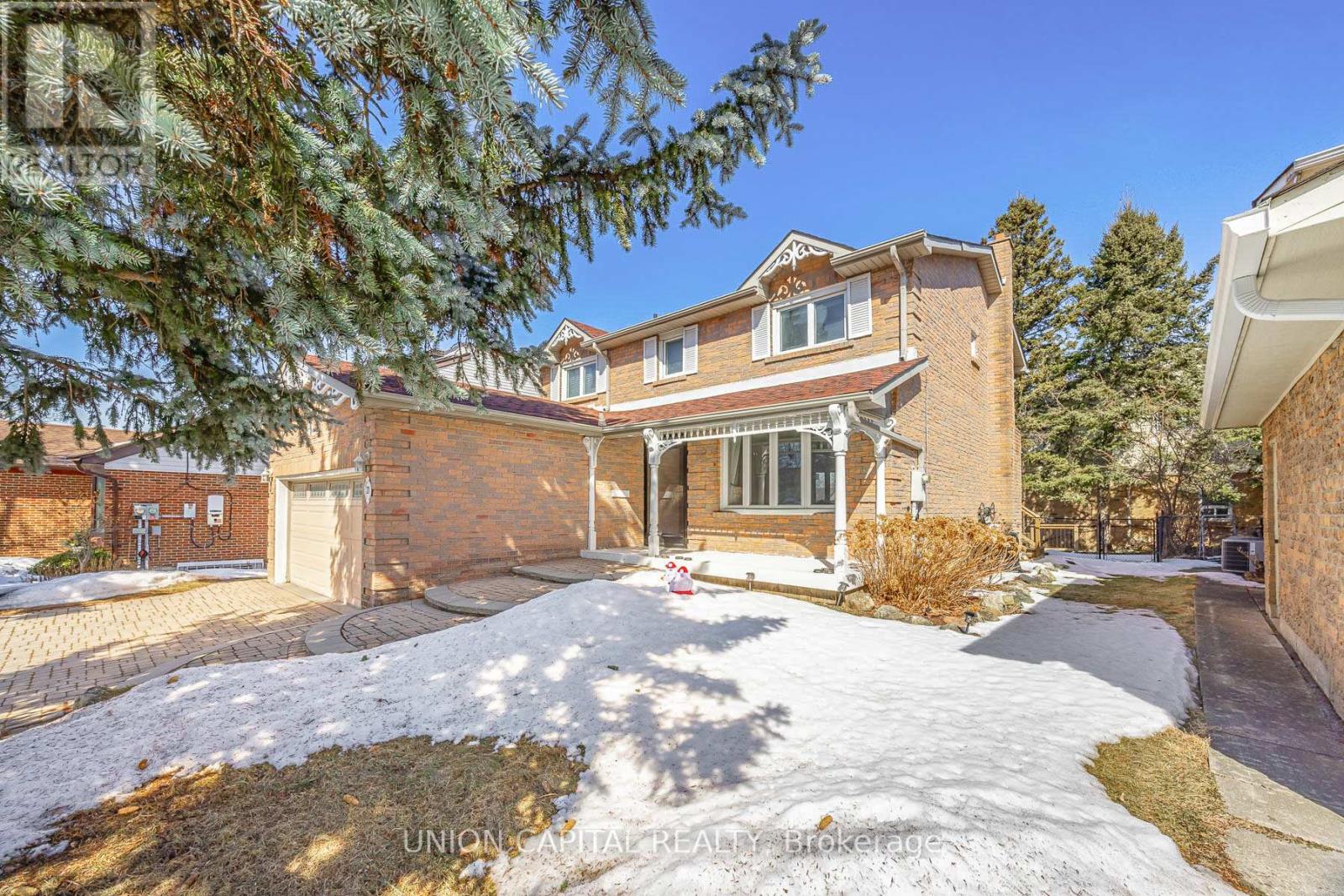 A house with a snow-covered front yard.