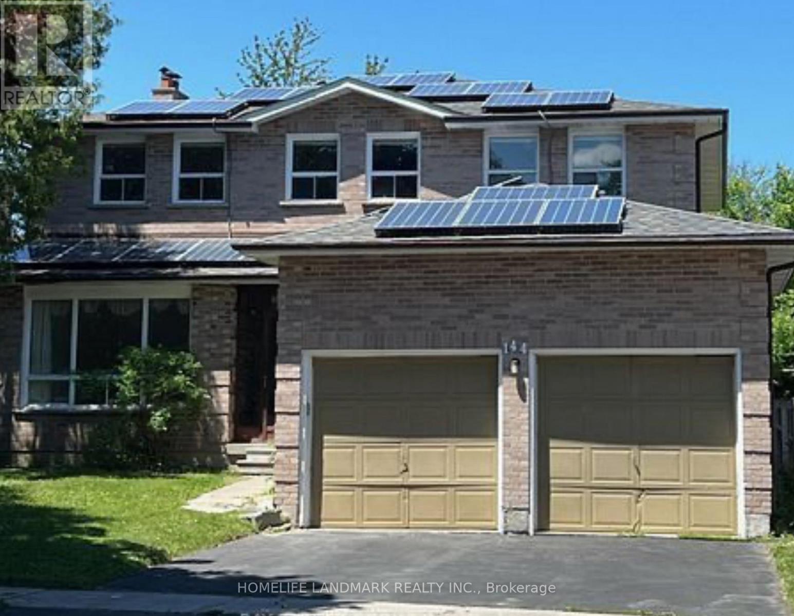 A house with a garage and solar panels on the roof.