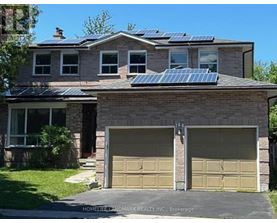 A house with a garage and solar panels on the roof.