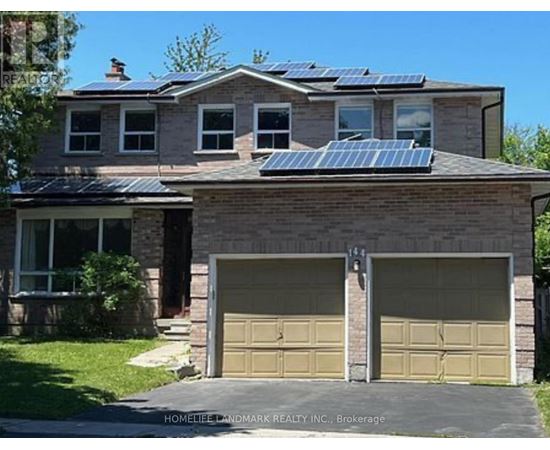 A house with a garage and solar panels on the roof.
