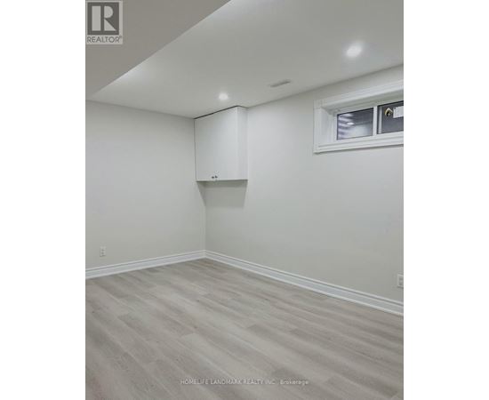 A room with a window and a cabinet built into the wall.