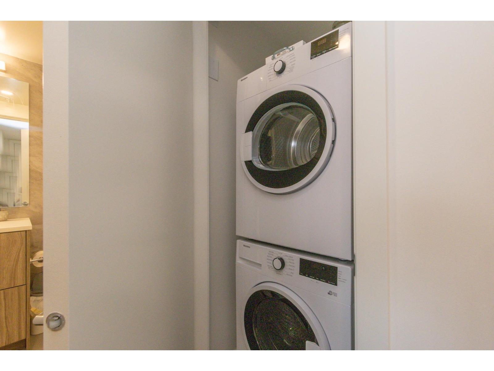 A white washing machine is in a small space.