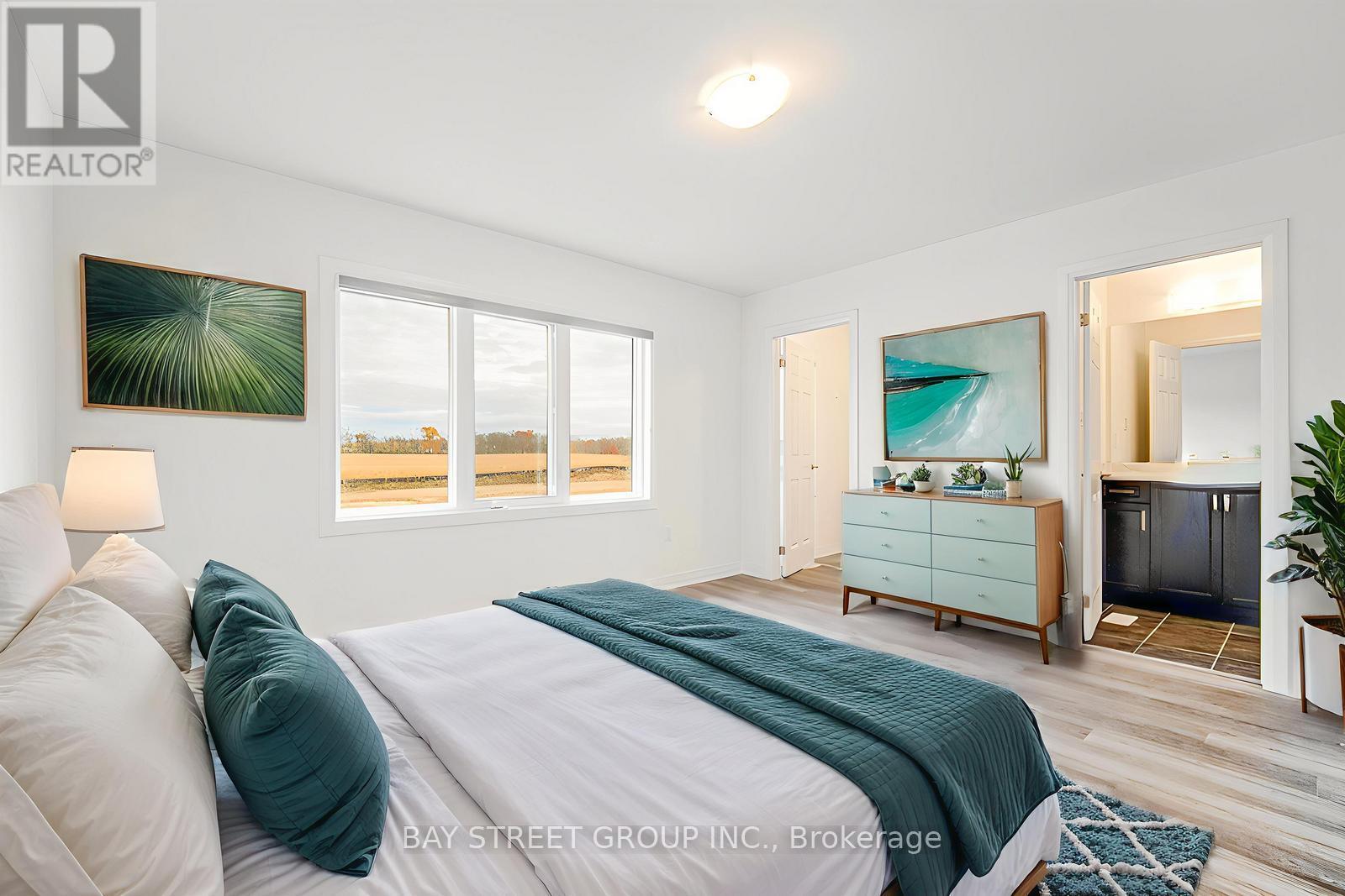A bedroom with a large bed and a painting on the wall.
