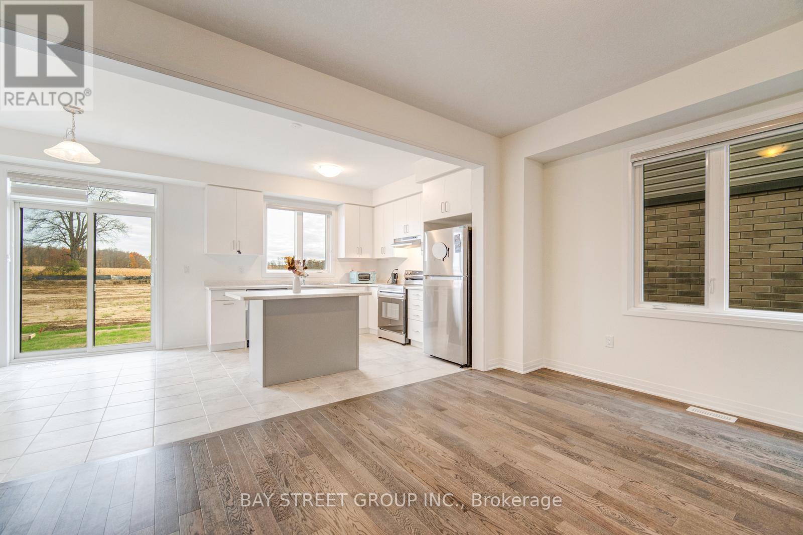 A spacious kitchen with white cabinets and a large island.
