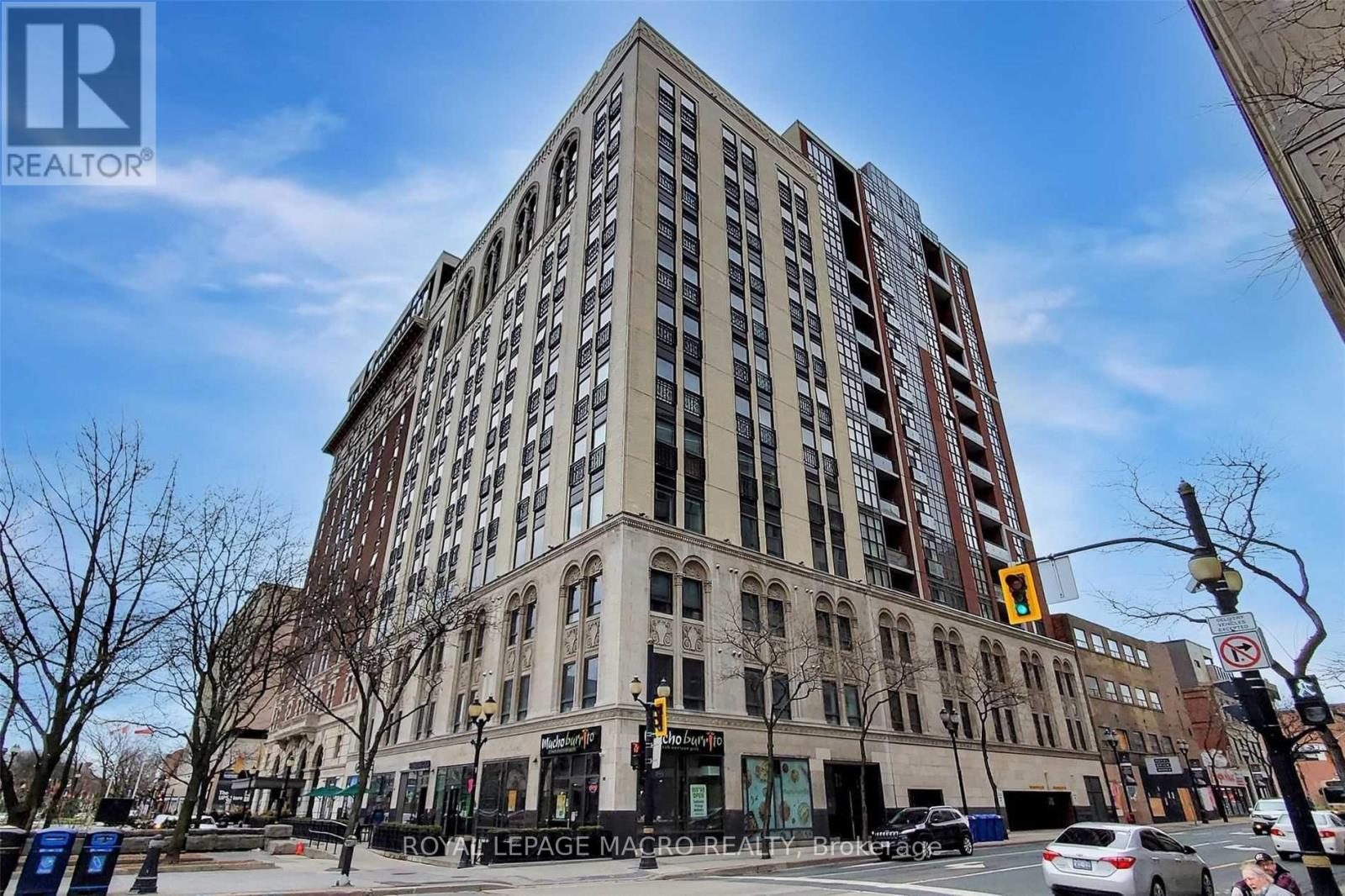 A tall building with a sign that says "REALTOR" on the top left corner.
