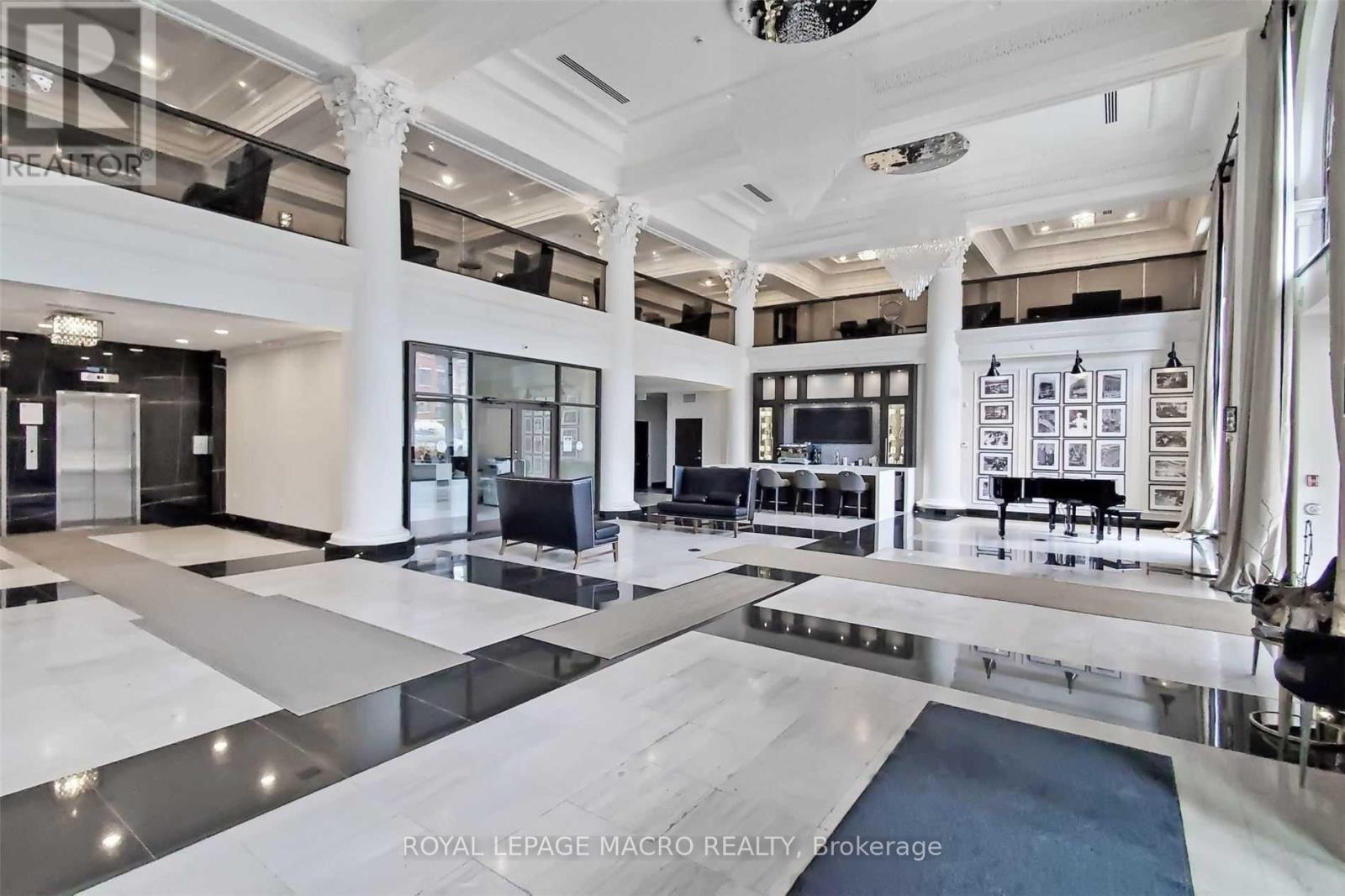 A spacious lobby with a checkered floor and a ceiling light fixture.